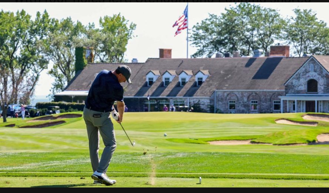 Mick Smith coaching a student on the golf course